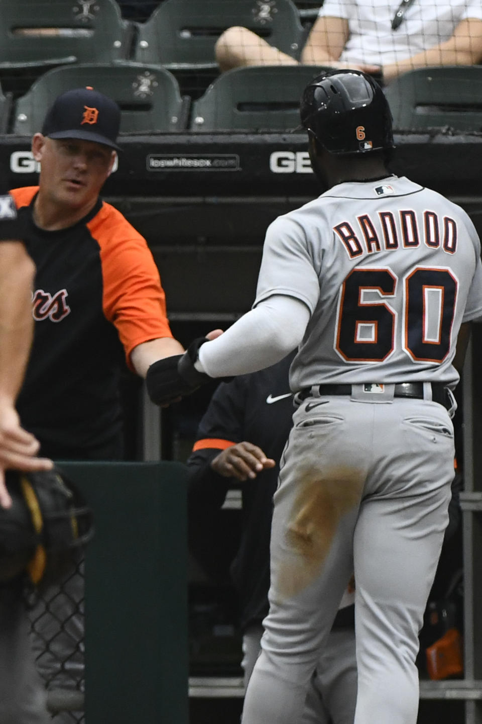 Detroit Tigers' Akil Baddoo (60) celebrates in the dugout after he scores during the fifth inning of a baseball game against the Chicago White Sox, Sunday, Oct. 3, 2021, in Chicago. (AP Photo/Matt Marton)