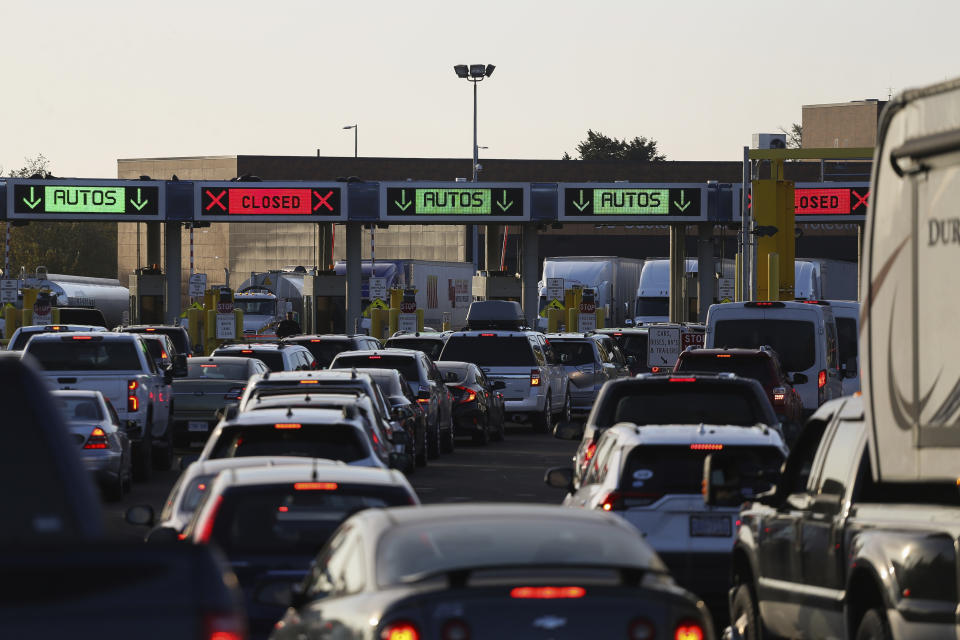 Cars line up at a checkpoint after crossing the Peace Bridge from Canada to the United States on Monday, Nov. 8, 2021, in Buffalo, N.Y. (AP Photo/Joshua Bessex)