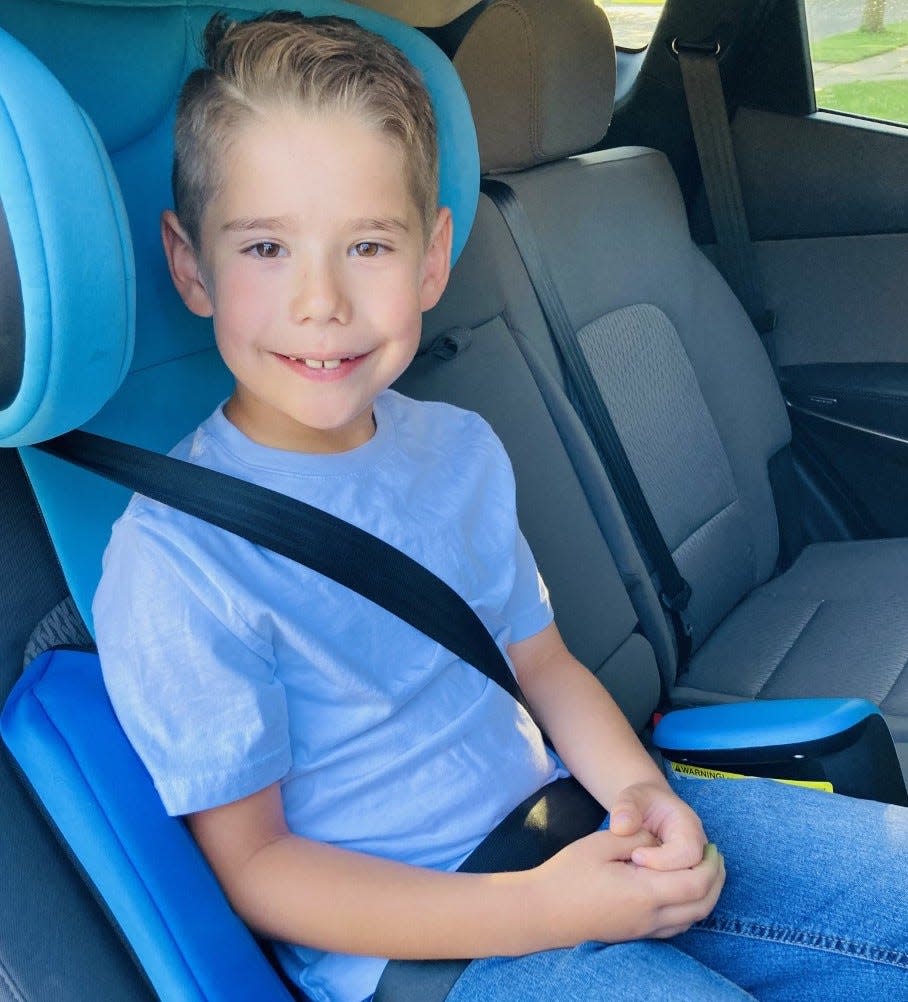 Keaton Pogue, 8, of Sioux Falls, smiles while safely buckled into a car seat before a ride. Keaton is the son of Emily Pogue, a program coordinator for the group South Dakota EMS for Children, which is leading a safe driving campaign.