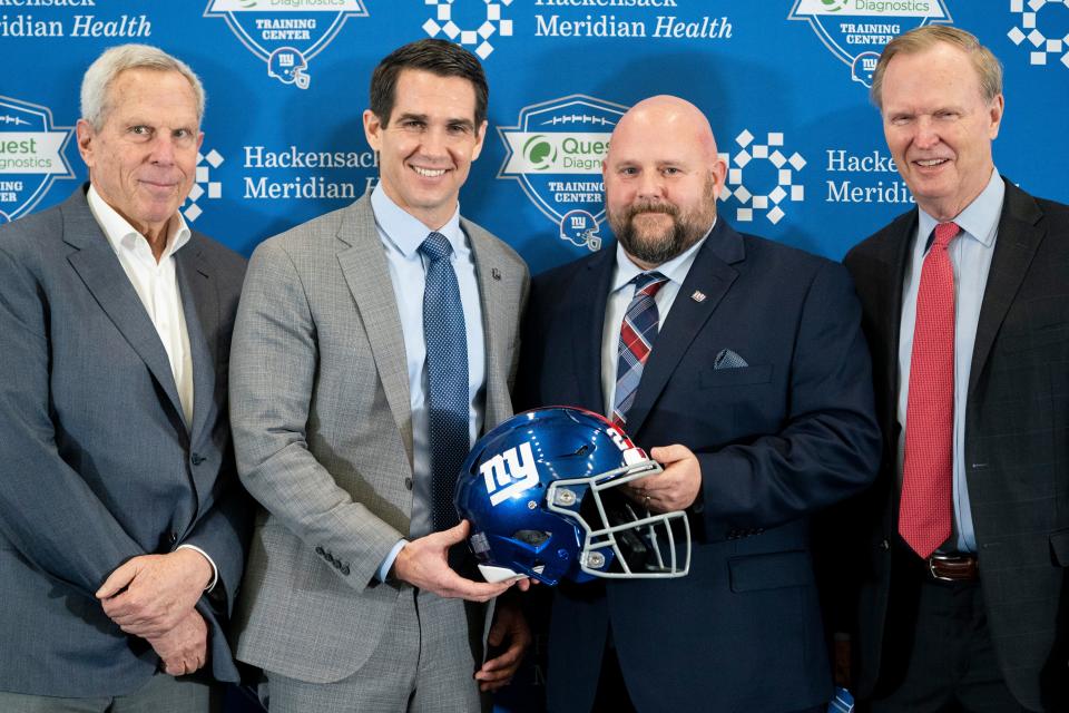 From left, New York Giants chairman and executive vice president Steve Tisch, general manager Joe Schoen,new head coach Brian Daboll, and president John Mara pose for a photograph during a news conference at the NFL football team's training facility, Monday, Jan. 31, 2022, in East Rutherford, N.J. (AP Photo/John Minchillo)
