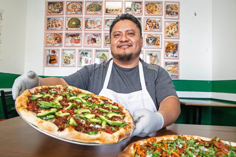 Chef Valentin Palillero shows a "Pizza Mexicana" pie at San Lucas Pizzeria, the restaurant he co-owns since 2005 with his wife, Eva Mendez, in Philadelphia, Tuesday, Sept. 19, 2023. Paillero is the first chef known to have made a specialty out of Mexican pizza in South Philly.