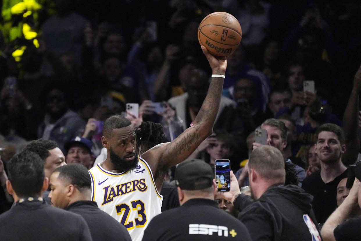 Los Angeles Lakers forward LeBron James acknowledges fans after scoring to become the first NBA player to reach 40,000 points in a career during the first half of an NBA basketball game Saturday, March 2, 2024, in Los Angeles. (AP Photo/Mark J. Terrill)