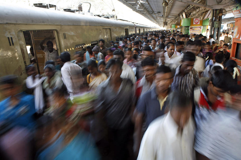 Indian commuters crowd a railway platform in Chennai, India.