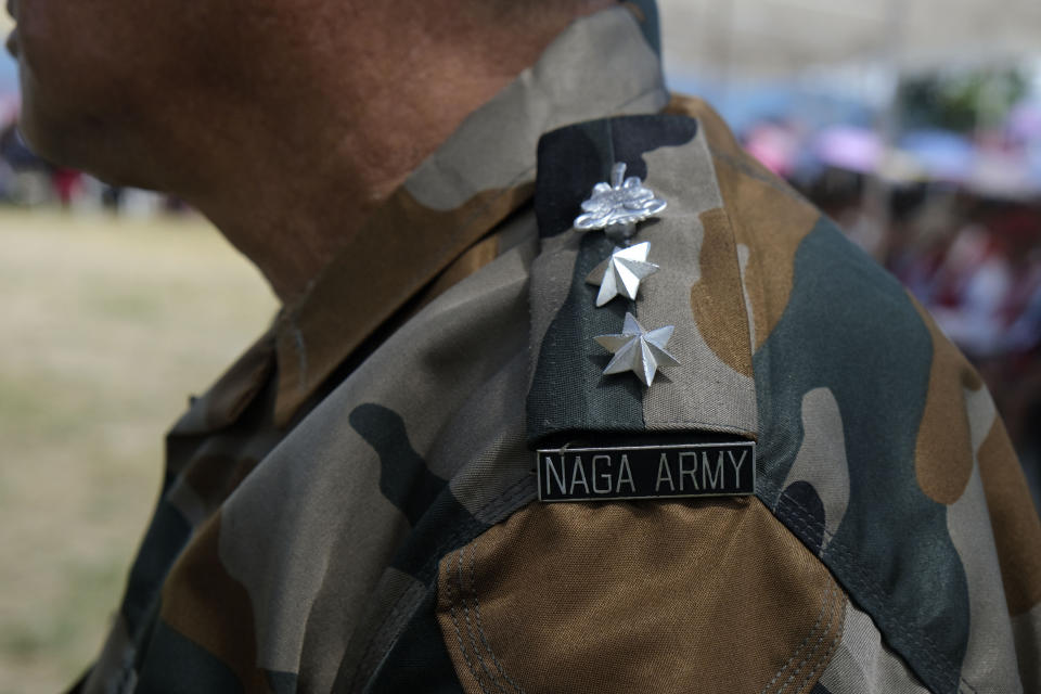 A Naga Army officer watches celebrations marking the Nagas' Declaration of Independence in Chedema, in the northeastern Indian state of Nagaland, Sunday, Aug. 14, 2022. The Nagas - an indigenous people inhabiting several northeastern Indian states and across the border in Myanmar - marked the 75th anniversary of their declaration of independence on Sunday. (AP Photo/Yirmiyan Arthur)