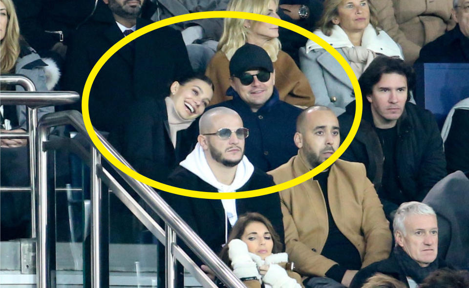 Leonardo DiCaprio and his girlfriend Camila Morrone, with DJ Snake below, attend the UEFA Champions League Group C