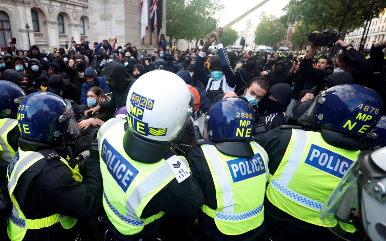 Demonstrators clash with police officers on Whitehall during a Black Lives Matter protest in London June 6 