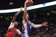 Philadelphia 76ers forward Danny Green (14) drives for the basket as Toronto Raptors forward Chris Boucher (25) defends during the second half of an NBA basketball game Thursday, April 7, 2022, in Toronto. (Frank Gunn/The Canadian Press via AP)