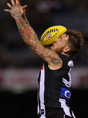 Dane Swan of the Magpies is hit in the face by the ball during the round twelve AFL match between the Collingwood Magpies and the Western Bulldogs at Etihad Stadium on June 16, 2013 in Melbourne, Australia.