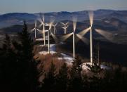 FILE - In this March 19, 2019 file photo, the blades of wind turbines catch the breeze at the Saddleback Ridge wind farm in Carthage, Maine. Scientists say emissions worldwide need to start falling sharply from next year if there is to be any hope of achieving the Paris climate accord’s goal of capping global warming at 1.5 degrees Celsius (2.7 Fahrenheit). (AP Photo/Robert F. Bukaty, File)