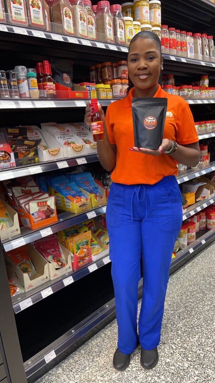 Quenella Clark, a Gainesville native and owner of "Miss Nola's" LLC., poses in the Enson Market in Orlando with her butter sauces and fry batter and mixes.
(Photo: Submitted photo)