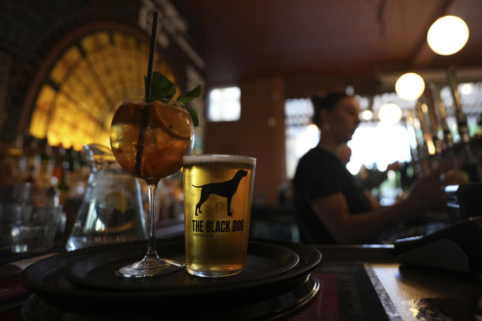 Drinks are prepared in the Black Dog pub, thought to be mentioned in a Taylor Swift song, in London, Saturday, May 4, 2024. As Taylor Swift prepares to launch the Europe leg of her blockbuster Eras tour, thousands of her fans from the U.S. and Canada are following her across the pond. Some Swifties decided to see Swift in one of the 18 cities on the pop star's tour after noticing that tighter restrictions on ticket fees and scalping in Europe made seeing Miss Americana perform abroad less of a splurge. (AP Photo/Alastair Grant)