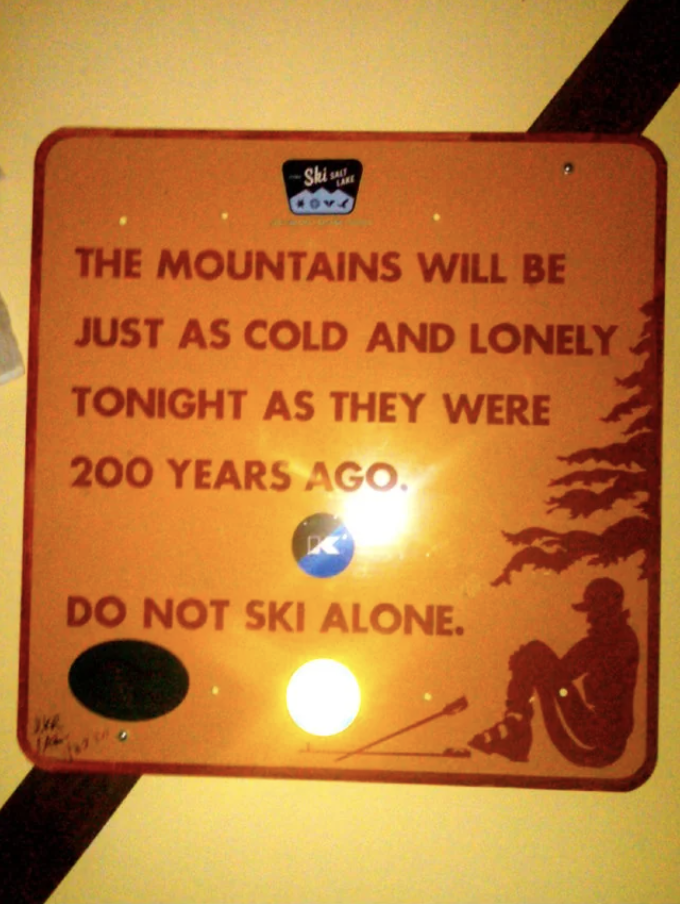 Warning sign advising not to ski alone because the mountains remain as cold and lonely as 200 years ago