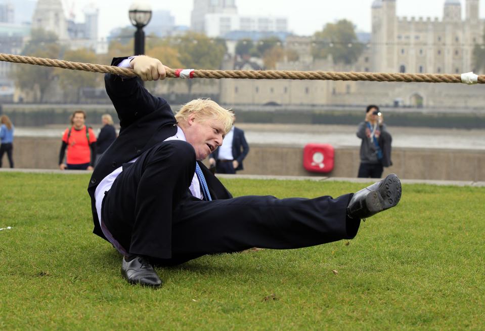 Mayor of London Boris Johnson falls over during a tug of war with personnel from the Royal Navy, the Army and the Royal Air Force at the launch of London Poppy Day, on Potters Field, next to City Hall in London.