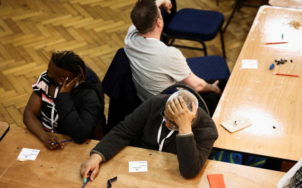 Counting staff rest during the counting process at the Westminster City Council local elections - REUTERS