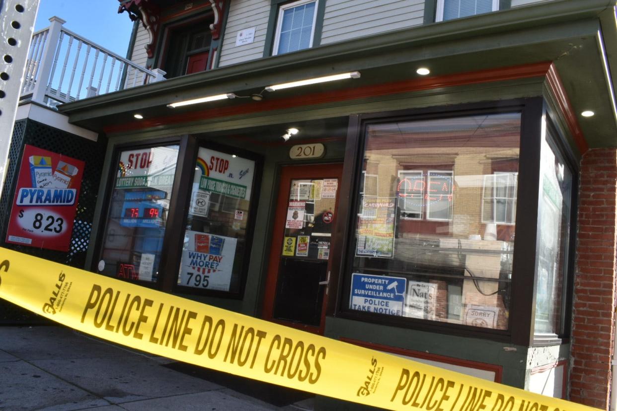 Police tape surrounds the Stop N Save convenience store at 201 Rock St., Fall River where a murder occurred in 2021.