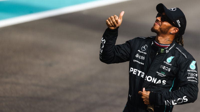 A photo of Lewis Hamilton smiling at fans. 