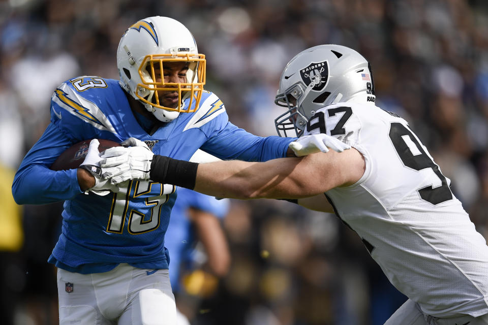 Los Angeles Chargers wide receiver Keenan Allen, left, is tackled by by Oakland Raiders defensive end Josh Mauro during the first half of an NFL football game Sunday, Dec. 22, 2019, in Carson, Calif. (AP Photo/Kelvin Kuo)