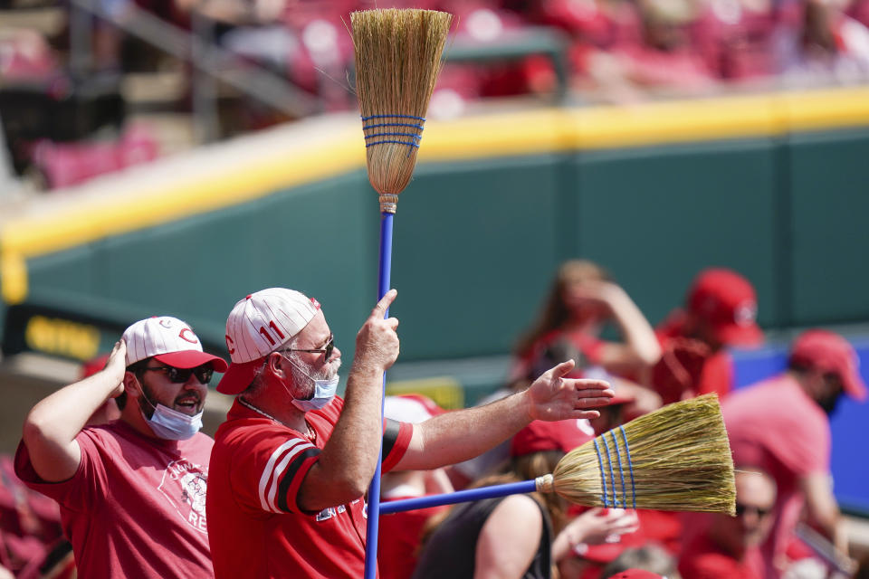 Cincinnati Reds' fans celebrate during the eighth inning of a baseball game against the Pittsburgh Pirates at Great American Ball Park in Cincinnati, Wednesday, April 7, 2021. (AP Photo/Bryan Woolston)