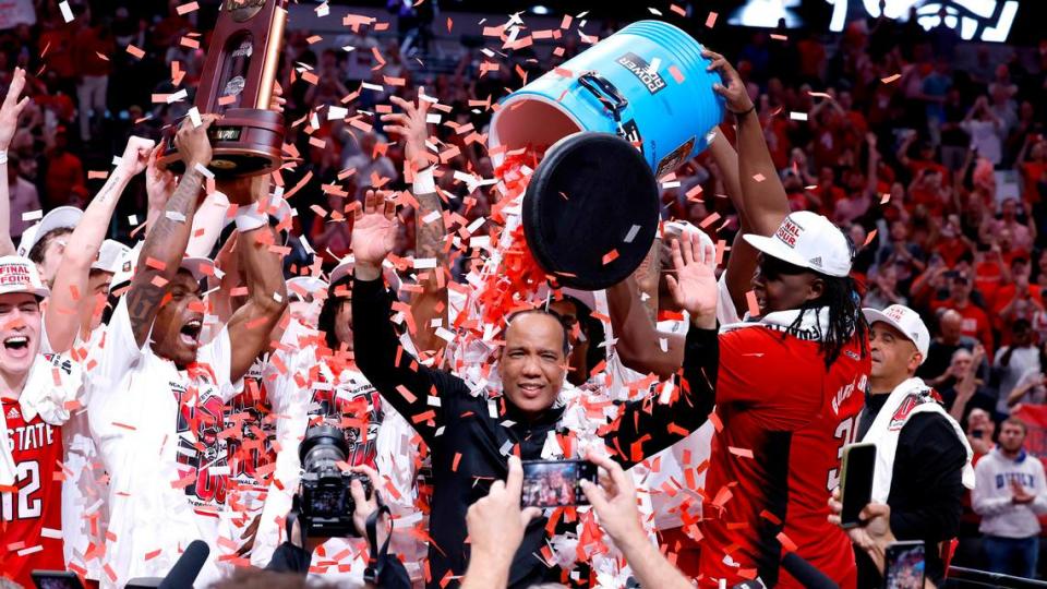 N.C. State head coach Kevin Keatts and the team celebrate the Wolfpack’s 76-64 victory over Duke in their NCAA Tournament Elite Eight matchup at the American Airlines Center in Dallas, Texas, Sunday, March 31, 2024.