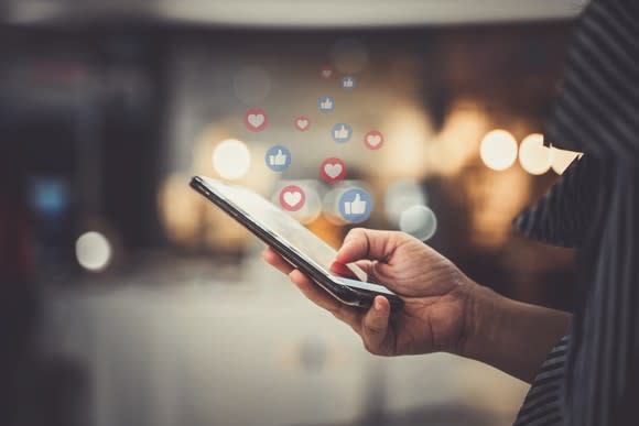 A woman uses a social media app on her phone.