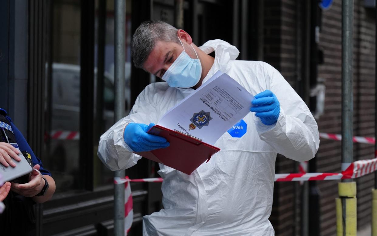 A police forensic investigator outside the disused building where the body was found