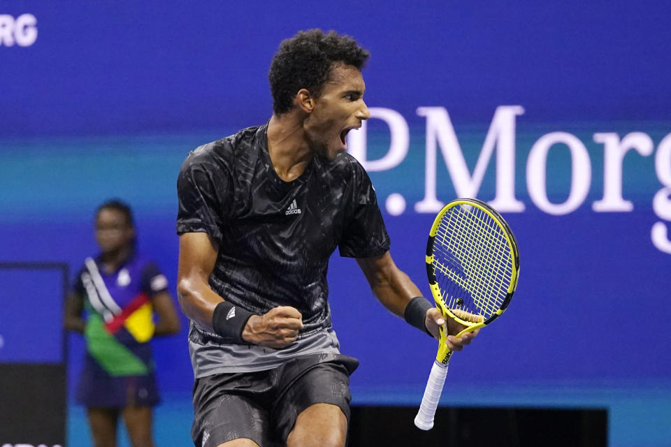 Felix Auger-Aliassime, of Canada, reacts after winning a game against Frances Tiafoe, of the United States, during the fourth round of the US Open tennis championships, Sunday, Sept. 5 2021, in New York. (AP Photo/Frank Franklin II)