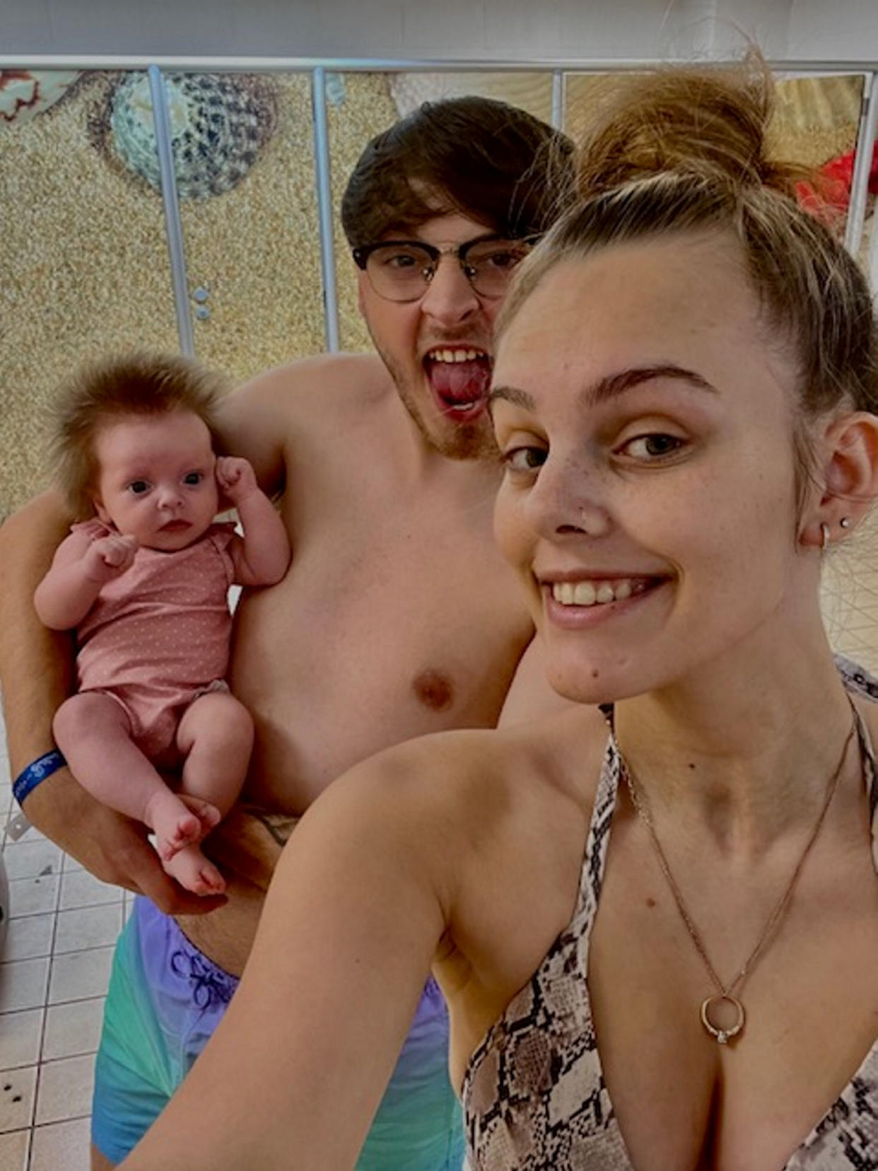 Pictured Aliyah Lewis and Adam Evans with their baby Arla who has 'crazy' hair. (Aliyah Lewis/SWNS)