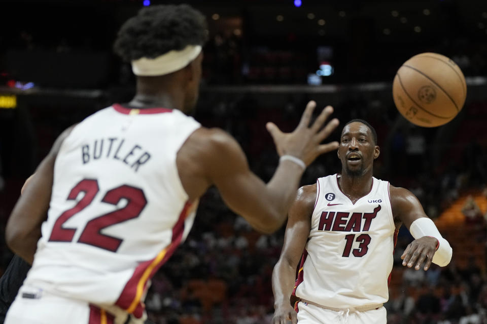 Miami Heat center Bam Adebayo (13) passes to forward Jimmy Butler (22) during the first half of an NBA basketball play-in tournament game against the Chicago Bulls, Friday, April 14, 2023, in Miami. (AP Photo/Rebecca Blackwell)