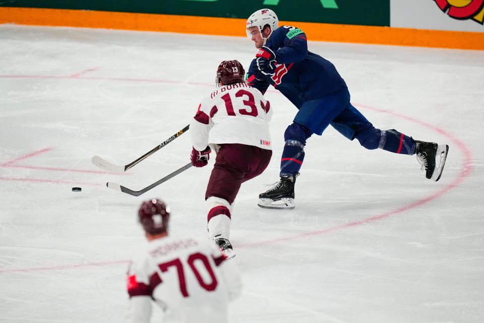 United States Carter Mazur (91) shoots against Latvia's Rihards Bukarts (13) in their bronze medal match at the Ice Hockey World Championship in Tampere, Finland, Sunday, May 28, 2023.