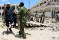 <p>Security forces assist Abdalla Boss, a Somali Member of Parliament who was wounded following a car bomb claimed by al Shabaab Islamist militants outside the president’s palace in the Somali capital of Mogadishu, August 30, 2016. (REUTERS/Feisal Omar) </p>