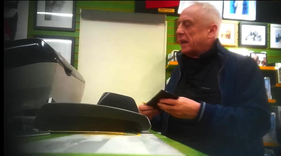 Anthony Beard at the counter of the Bromley branch of Snappy Snaps.