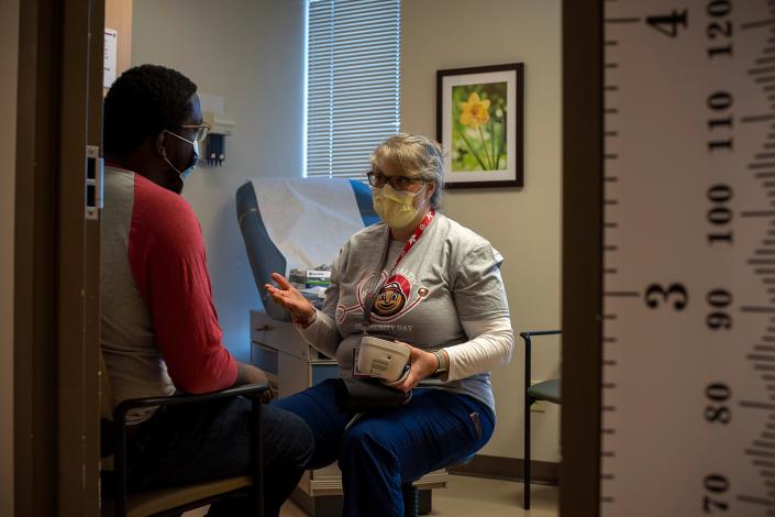 Angel Edwards-Hedberg, patient care resource manager at the Ohio State Wexner Medical Center, checks Ferdinand Vilson's blood pressure Saturday, June 4, 2022, during Ohio State University Wexner Medical Center’s Healthy Community Day at Ohio State Outpatient Care East.