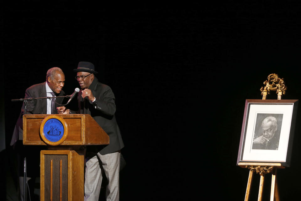 Actors Danny Glover, left, and Glynn Turman speak during the funeral of poet Amiri Baraka Saturday, Jan. 18, 2014, in Newark, N.J. The 79-year-old author of blues-based poems, plays and criticism died Jan. 9 of an undisclosed illness. (AP Photo/Jason DeCrow)