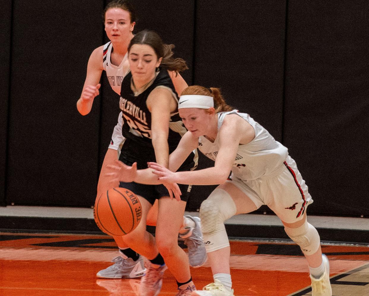 Biglerville’s Claire Roberts, left, and South Western’s McKayla Green go for a loose ball in the first round of the Hanover Hawkettes Holiday Classic on Tuesday, Dec. 27, 2022. The Mustangs won 44-34.