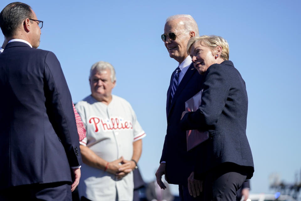 Energy Secretary Jennifer Granholm rests her head on President Joe Biden's shoulder after he arrived at Philadelphia International Airport, Friday, Oct. 13, 2023, in Philadelphia. Pennsylvania Gov. Josh Shapiro, left, and former Rep. Bob Brady second from left, look on. (AP Photo/Evan Vucci)