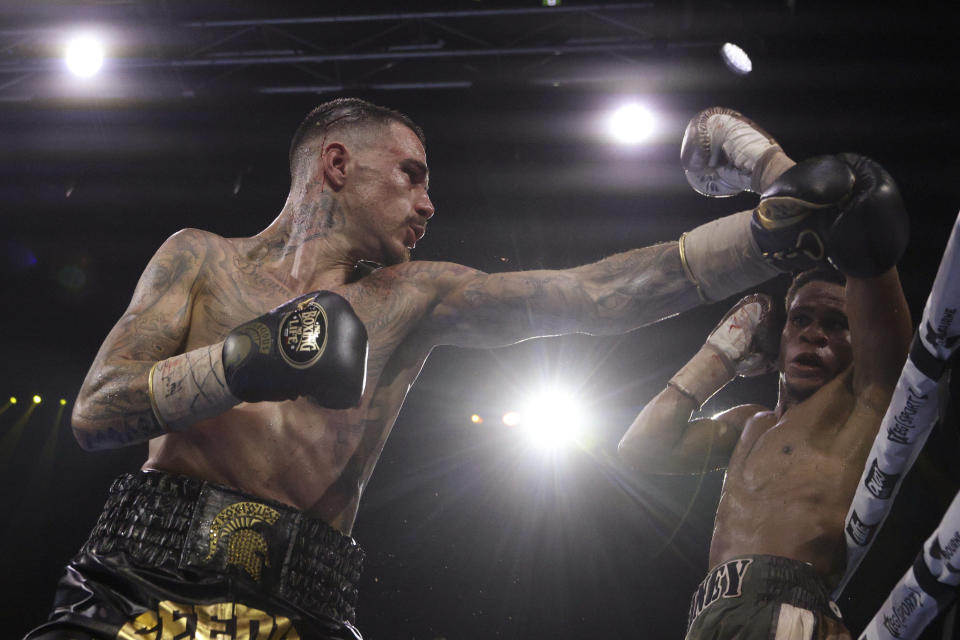 George Kambosos Jr. of Australia, left, and United States' Devin Haney compete as Haney defends his undisputed lightweight boxing title in Melbourne, Sunday, Oct. 16, 2022. (AP Photo/Hamish Blair)