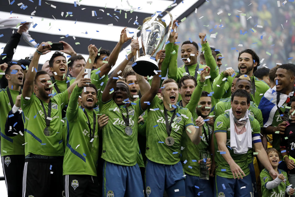 The Seattle Sounders celebrate after beating Toronto FC 3-1 Sunday to win their second MLS Cup title. (AP Photo/Elaine Thompson)