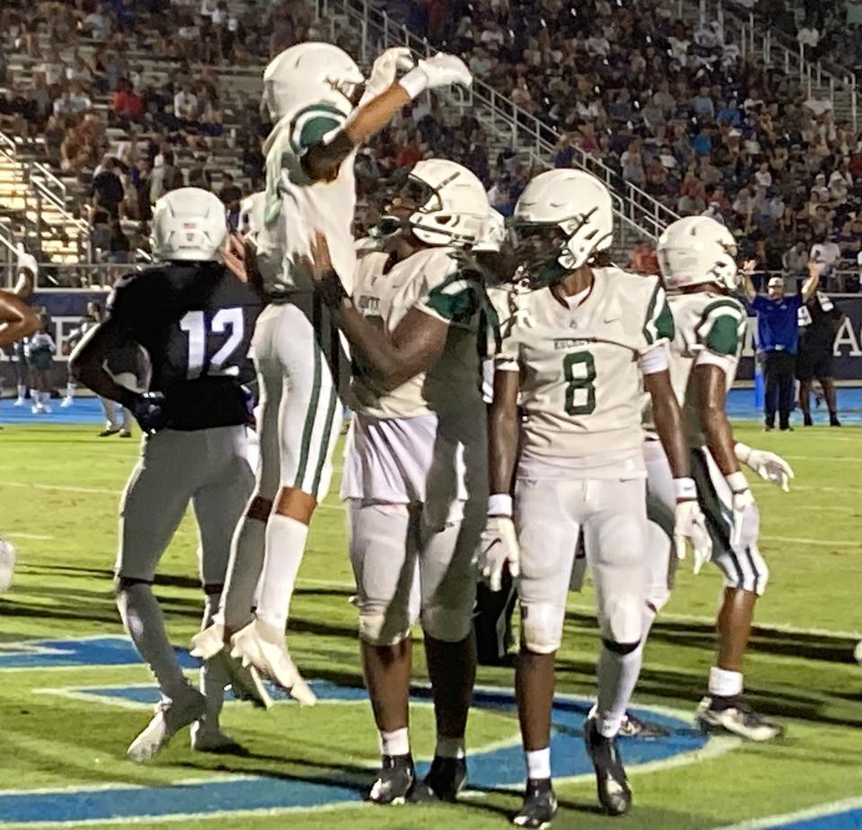 Miami Central players celebrate Sekou Smith's third quarter touchdown against IMG. Central won 20-14.