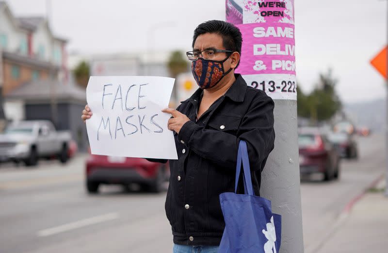 Marcos Hernandez stands on Vermont Avenue selling homemade face masks during the outbreak of the coronavirus disease (COVID-19) in Los Angeles, California