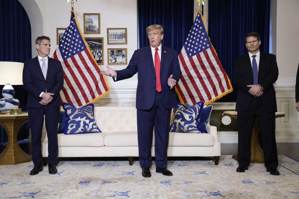 Former President Donald Trump speaks to the media at a Washington hotel, Tuesday, Jan. 9, 2024, after attending a hearing before the D.C. Circuit Court of Appeals at the federal courthouse in Washington, with attorneys John Lauro, left, and D. John Sauer, right. (AP Photo/Susan Walsh)