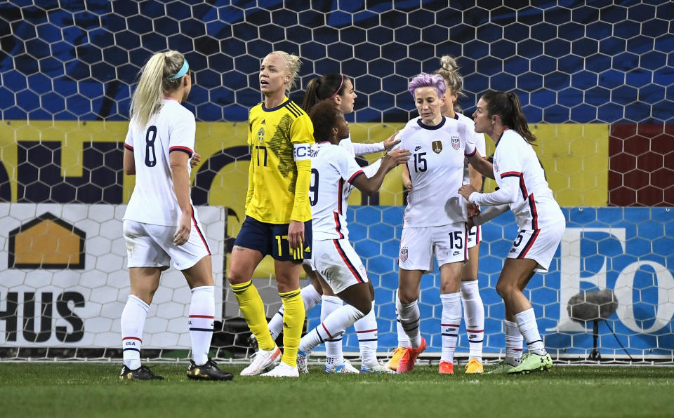 Megan Rapinoe (15) of USA celebrates with teammates after scoring a goal on a penalty kick during the women's international friendly soccer match between Sweden and USA at Friends Arena in Stockholm, Sweden, Saturday, April 10, 2021. (Janerik Henriksson/TT via AP)