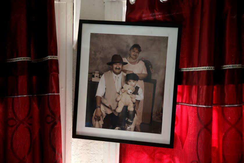 A portrait of Victoria (Vicky) Escalante, with deceased husband Yelman (cq) Oviedo, and grandchild Brian Oviedo, 4