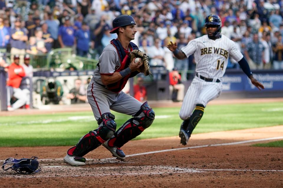 Andruw Monasterio of the Brewers is forced out at home as Nationals catcher Drew Millas takes the throw with bases loaded during the 10th inning Sunday at American Family Field.