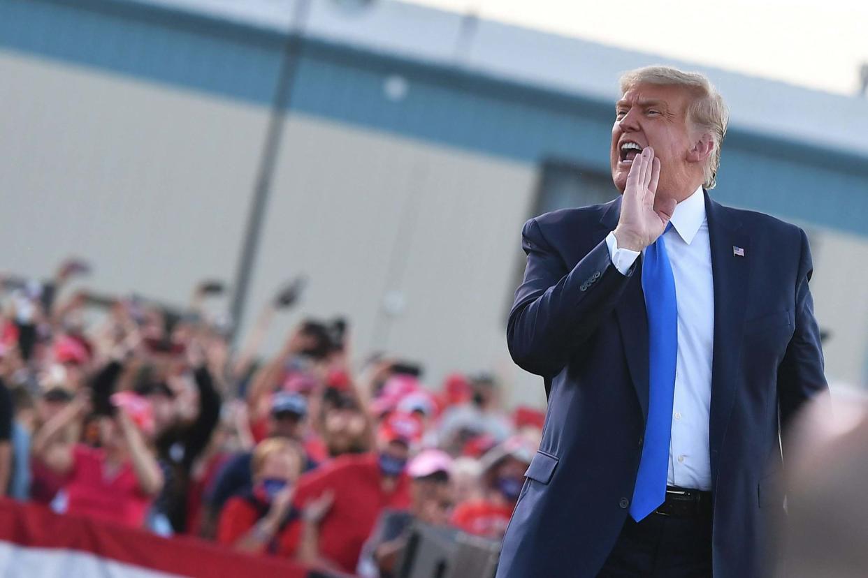 US President Donald Trump speaks to supporters as he makes his way off stage at the end of a rally at Carson City Airport in Carson City, Nevada: AFP via Getty Images