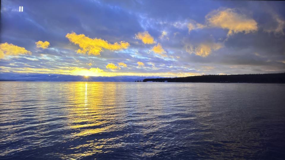 TCL QM851G TV showing image of sunset on a lake