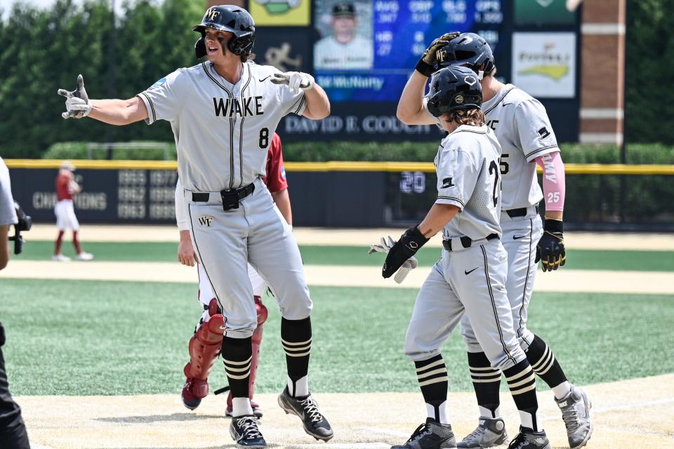 Wake Forest's Nick Kurtz (8) celebrates with Tommy Hawke and Brock Wilken after hitting a home run against Alabama at their super regional game Sunday, June 11, 2023, in Winston-Salem, N.C.