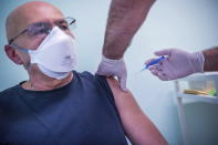 A man receives a shot of the Russian vaccine Sputnik V at the South Pest Central Hospital in Budapest, Hungary, Friday, Feb. 12, 2021, as the vaccination with Sputnik V against the new coronavirus begins in the country. (Zoltan Balogh/MTI via AP)