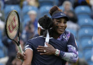 Serena Williams of the United States, right, and Ons Jabeur of Tunisia celebrate after wining their doubles tennis match against Marie Bouzkova of Czech Republic and Sara Sorribes Tormo of Spain at the Eastbourne International tennis tournament in Eastbourne, England, Tuesday, June 21, 2022. (AP Photo/Kirsty Wigglesworth)