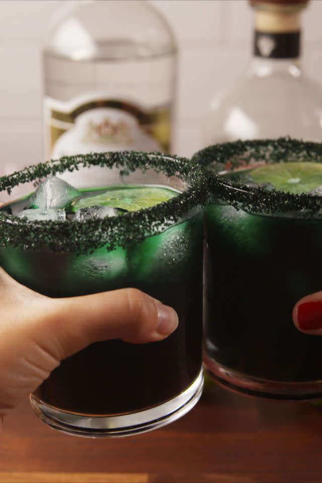 <p>Green food coloring makes this silver tequila and triple sec margarita extra spooky. You can also use red or blue for a different color effect.</p><p><em>Get the recipe from <a href="https://www.delish.com/cooking/recipe-ideas/recipes/a55953/black-magic-margaritas-recipe/" rel="nofollow noopener" target="_blank" data-ylk="slk:Delish;elm:context_link;itc:0;sec:content-canvas" class="link ">Delish</a>.</em> </p>