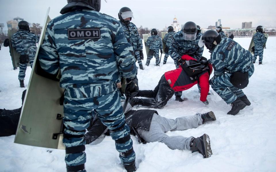 Police detain men during a protest against the jailing of opposition leader Alexei Navalny in Yekaterinburg